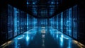 High-tech data center corridor illuminated with blue lighting, featuring rows of server racks and reflective floor surfaces Royalty Free Stock Photo
