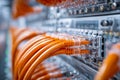 High-tech data center servers connected with organized orange network cables showcasing modern digital infrastructure and Royalty Free Stock Photo