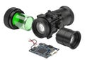 High-tech disassembled night vision scope with green illuminated components and electronic circuit board Royalty Free Stock Photo