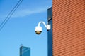 High tech overhead security camera with dark thunderstorm sky. Royalty Free Stock Photo