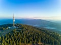 Tower Snezhanka in Rhodope mountains with fog, forest, sunbeams and sunny clouds Royalty Free Stock Photo