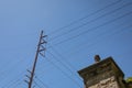 High tension power lines against a blue sky, stone column with finial, creative copy space Royalty Free Stock Photo