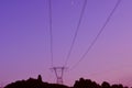 High tension power lines hill top twilight sunset