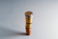 High tower of coins. Euro coins and euro cents stacked on top of each other in a high pile. 2 Euro coin on top. Soft focus Royalty Free Stock Photo