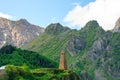 High traditional tower of Georgia on the background of high mountains Royalty Free Stock Photo