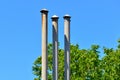 High triple chimney at the house next to the green trees Royalty Free Stock Photo