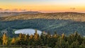 High View of a Mountain Lake Looking Over Evergreens and Pine Trees Royalty Free Stock Photo