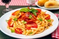 High view of a plate of spaghetti pasta with a delicious homemade tomato sauce with homemade basil leaves. Homemade and natural Royalty Free Stock Photo