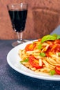 High view of a plate of spaghetti pasta with a delicious homemade tomato sauce with homemade basil leaves. Homemade and natural Royalty Free Stock Photo
