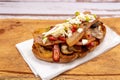 High view of a rustic bread brusquette with mayonnaise, bacon, mushrooms and vinaigrette, drizzled with EVOO or olive oil. Typical