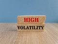 High volatility symbol. Concept red words High volatility on brick bloks. Beautiful blue background. Business high volatility