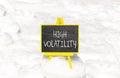 High volatility symbol. Concept words High volatility on beautiful black chalk blackboard. Chalkboard. Beautiful snow background.