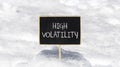 High volatility symbol. Concept words High volatility on beautiful black chalk blackboard. Chalkboard. Beautiful snow background.