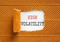 High volatility symbol. Concept words High volatility on beautiful white paper. Beautiful brown paper background. Business high