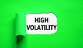 High volatility symbol. Concept words High volatility on beautiful white paper. Beautiful green paper background. Business high