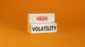 High volatility symbol. Concept words High volatility on beautiful wooden blocks. Beautiful orange table orange background.