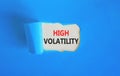 High volatility symbol. Concept words High volatility on beautiful white paper. Beautiful blue paper background. Business high