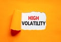 High volatility symbol. Concept words High volatility on beautiful white paper. Beautiful orange paper background. Business high