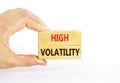 High volatility symbol. Concept words High volatility on beautiful wooden blocks. Beautiful white table white background.