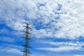 High voltage cable on electrical tower with blue sky and beautiful cloud background Royalty Free Stock Photo
