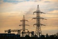 High voltage cable power post steel tower pylons in sunset Royalty Free Stock Photo