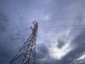 High voltage cable tower with cloudy sky