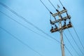 High voltage cables and equipments on pole with clear blue sky background Royalty Free Stock Photo