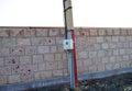 High voltage column near the brick wall Royalty Free Stock Photo