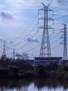 high voltage electric pole isolated in blue sky and water background Royalty Free Stock Photo