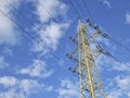 High voltage electric pole and power lines, high voltage electric transmission tower and blue cloudy sky Royalty Free Stock Photo