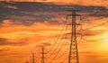 High voltage electric pole and transmission line in the evening. Electricity pylons at sunset. Power and energy. High voltage grid Royalty Free Stock Photo