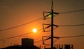 High voltage electric pole and transmission lines in the city. Electricity pylons at sunset. Power and energy. Energy conservation Royalty Free Stock Photo