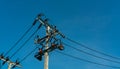 High voltage electric pole and transmission lines with clear blue sky. Electricity pylons. Power and energy engineering system. Royalty Free Stock Photo