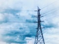 High voltage electric power pole under blue cloud. Royalty Free Stock Photo