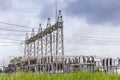 High voltage electric power substation with cloudy dark sky background Royalty Free Stock Photo