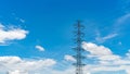 High voltage electric pylon and electrical wire against blue sky and white clouds. Electricity pylon. Power and energy concept. Royalty Free Stock Photo