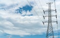 High voltage electric pylon and electrical wire with blue sky and white clouds. Tall electricity pole. Power and energy concept. Royalty Free Stock Photo