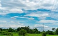 High voltage electric pylon and electrical wire with blue sky and white clouds. Tall electricity pole. Power and energy concept. Royalty Free Stock Photo