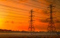 High voltage electric pylon and electrical wire with sunset sky. Electricity poles. Power and energy concept. High voltage grid Royalty Free Stock Photo