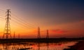High voltage electric pylon and electrical wire with sunset sky. Electricity poles. Power and energy concept. High voltage grid Royalty Free Stock Photo