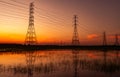 High voltage electric pylon and electrical wire with sunset sky. Electricity poles. Power and energy concept. High voltage grid Royalty Free Stock Photo