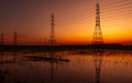 High voltage electric pylon and electrical wire with sunset sky. Electricity poles. Power and energy concept. High voltage grid