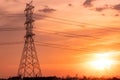 High voltage electric pylon and transmission lines with sunset sky and cityscape. Electricity pylons. High voltage grid tower. Royalty Free Stock Photo