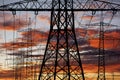 High voltage and electric pylons against sky with clouds Royalty Free Stock Photo