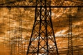 High voltage and electric pylons against sky with clouds Royalty Free Stock Photo