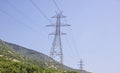 High voltage electric pylons at Greek forest mountain background. Energy transmission concept