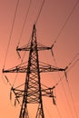 High voltage electric tower silhouette on bright orange background Royalty Free Stock Photo
