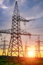 High voltage electric tower. Silhouette on sunset time. Power pylons on sunset time background. Selective focus Royalty Free Stock Photo