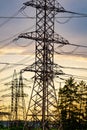 High voltage electric tower. Silhouette on sunset time. Power pylons on sunset time background. Selective focus Royalty Free Stock Photo