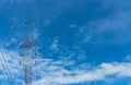 High voltage electric tower and transmission lines. Electricity pylon with blue sky and white clouds. Power and energy Royalty Free Stock Photo